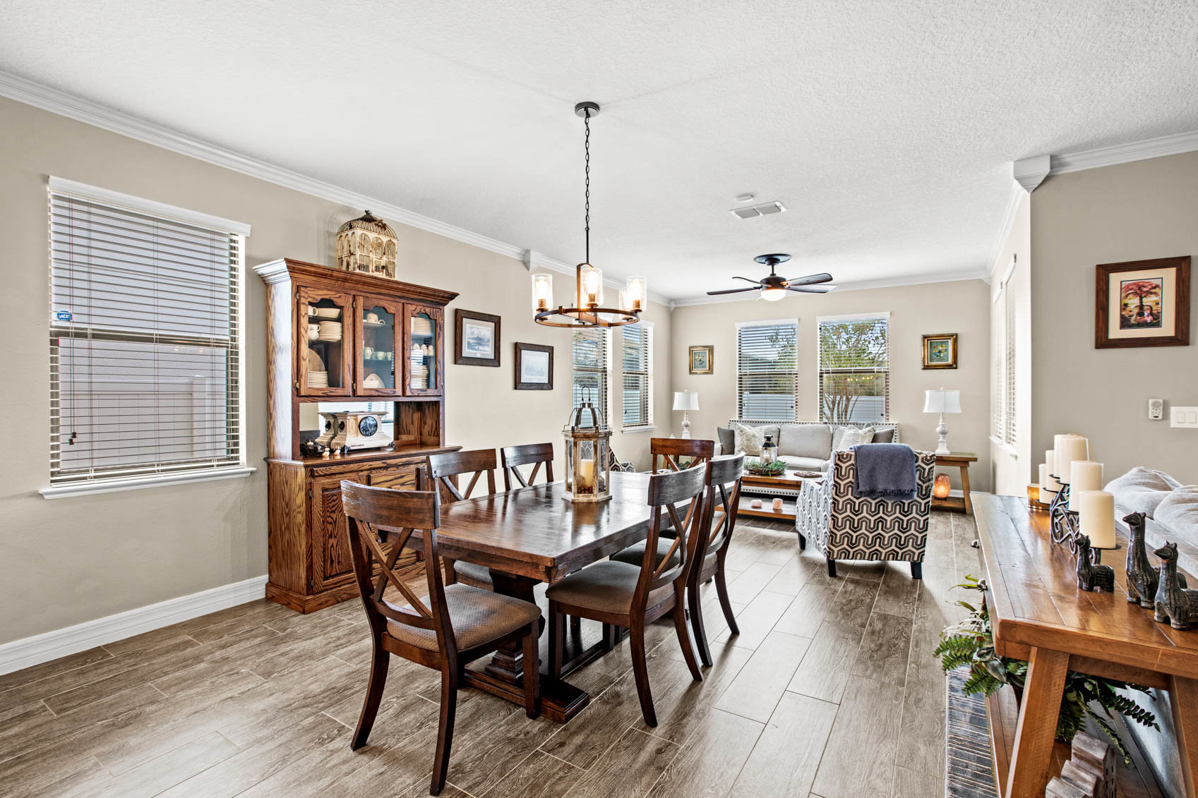 dining area with brown table and chairs and sitting area with windows